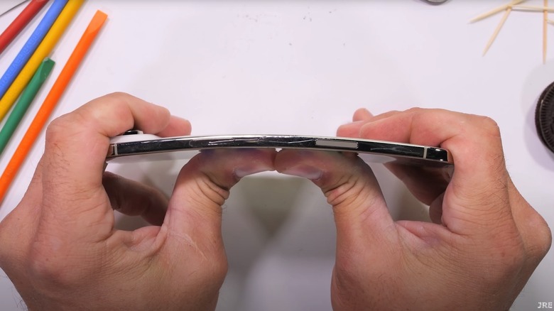 JerryRigEverything's Zack attempting to bend the iPhone Air by hand
