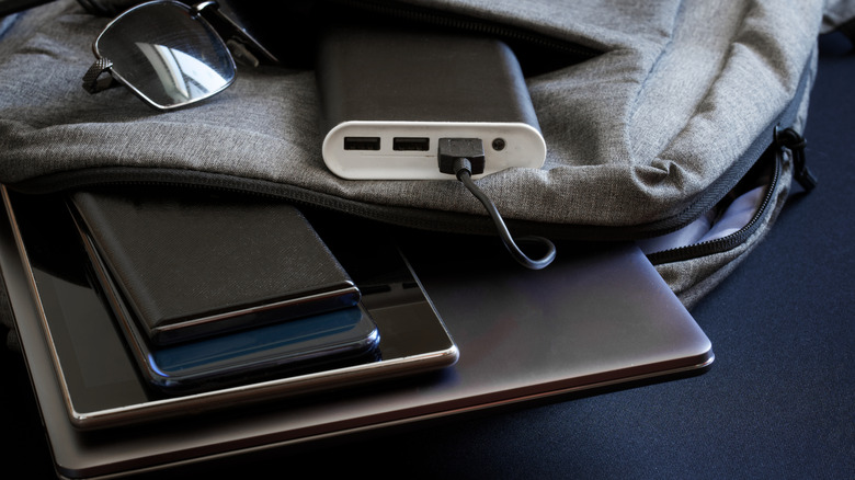 Backpack with USB power bank and gadgets hanging out.