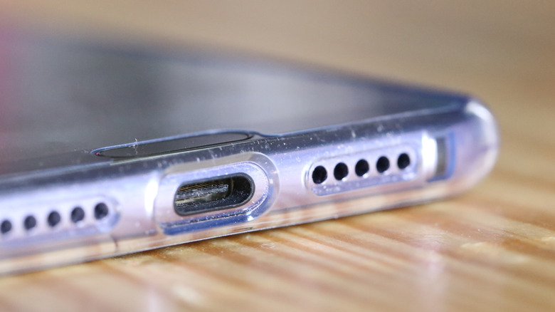 Close up of a dirty USB-C port on the bottom of a smartphone.