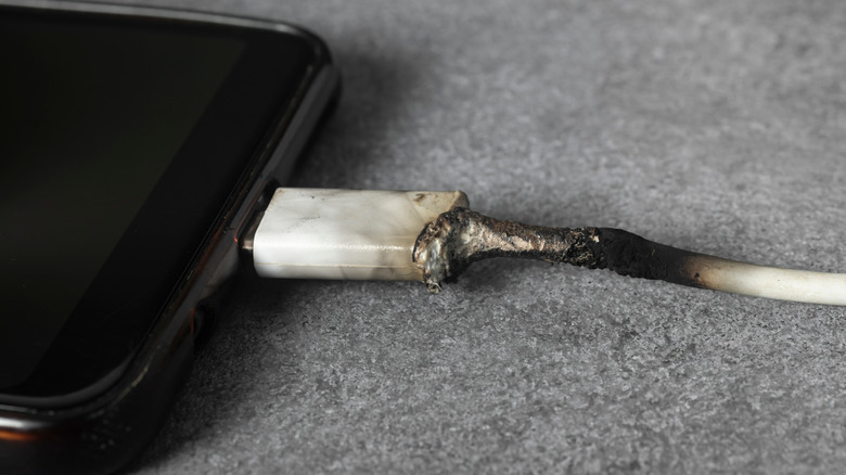 Melted USB-C cable plugged into a smartphone.