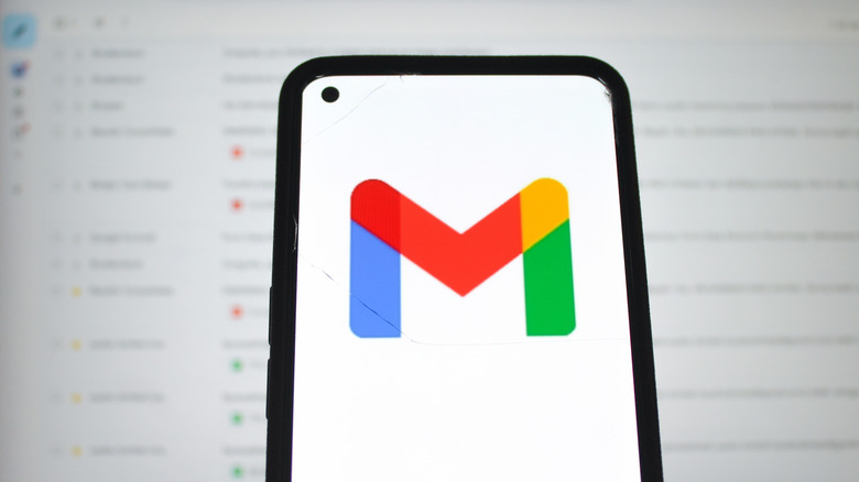 Gmail icon on smartphone. in front of blurred screen