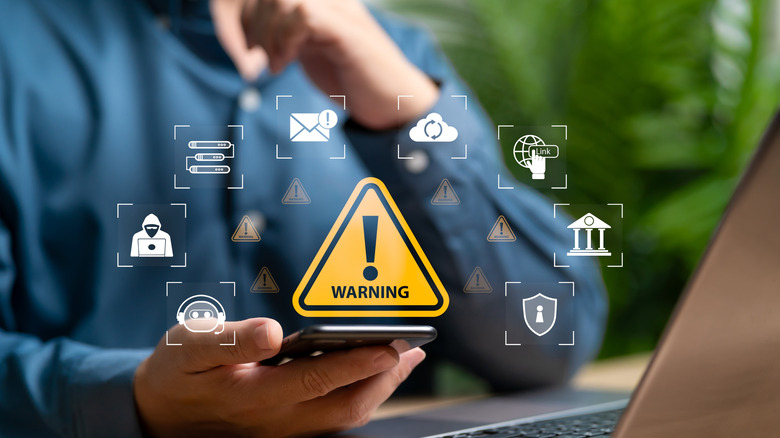 data theft / surveillance warning concept, man holding smartphone, floating icons for email, messages, cloud service, bank, more