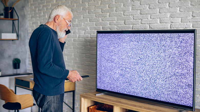Elderly man on the phone discussing TV problems