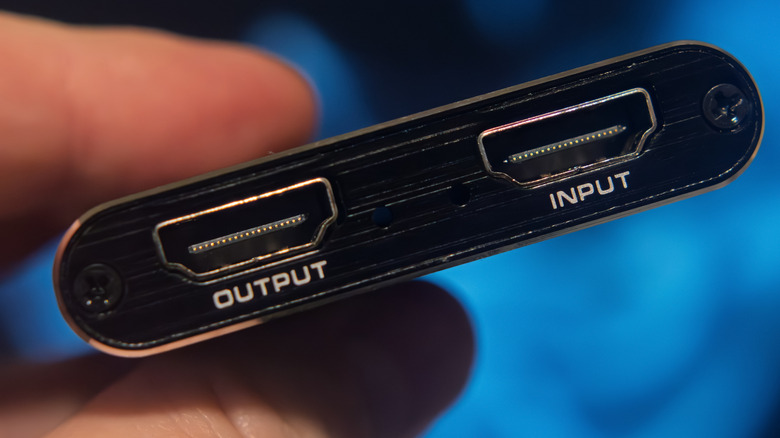 Close up of HDMI input and output ports on a small adapter.