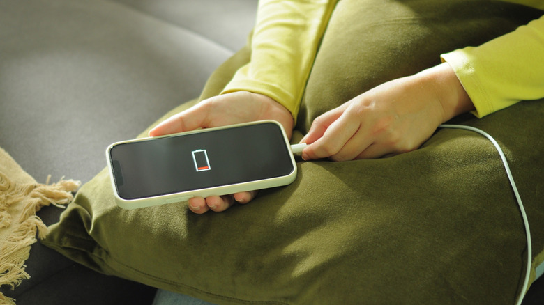 A person trying to charge a phone with low battery