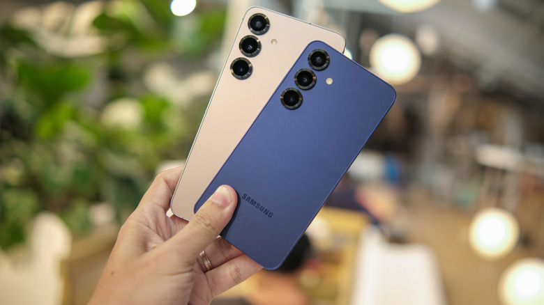 Person holding two Samsung Galaxy devices
