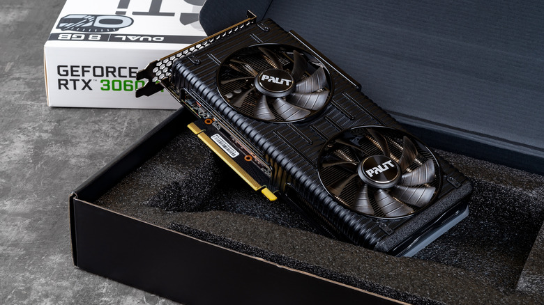 GeForce RTX 3060 graphics card displayed beside retail box and packaging foam