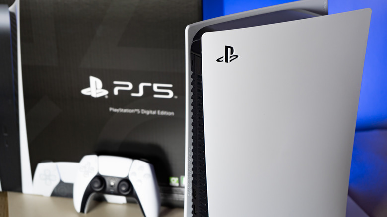 PS5 console next to its box with a controller visible