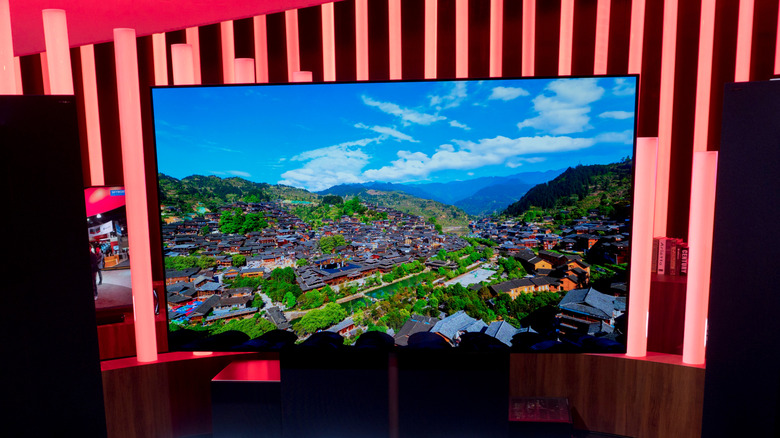 A showcase with an 88-inch 8K OLED TV turned on