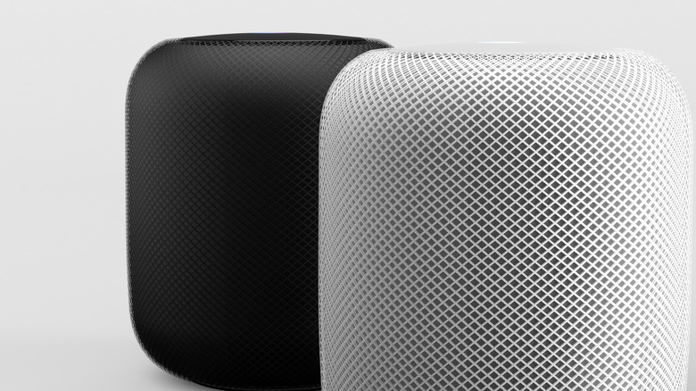Two Apple HomePods in black and white