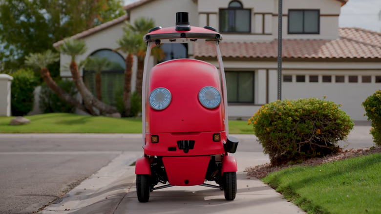 The DoorDash delivery robot, DoorDash Dot, on a sidewalk.