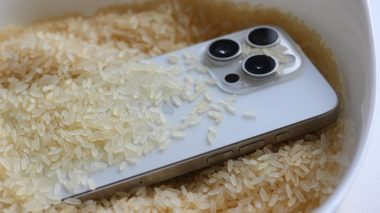 Smartphone placed in dry rice as a common remedy to remove moisture.