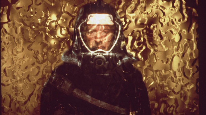 Dr. Norman Goodman in full diving gear looking through the orb