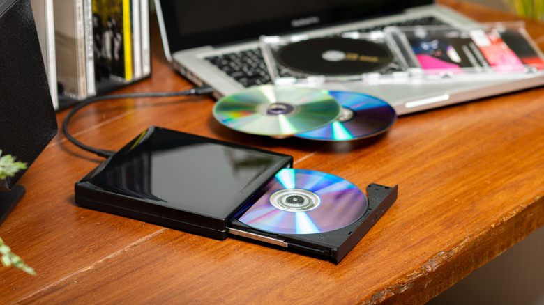 An external DVD player and some discs lying around