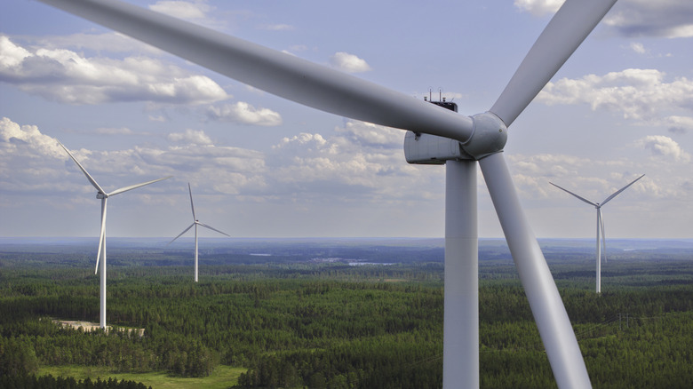 Close up of a wind turbine with other turbines in the background