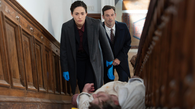 Alice and Danny examining a dead body