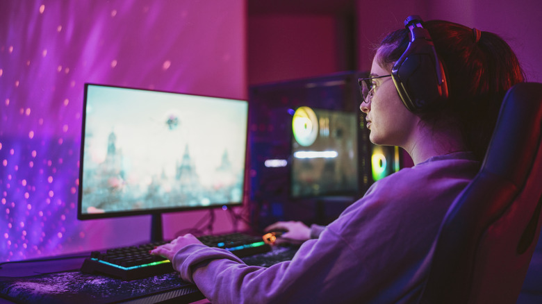Woman playing a PC game at a desk