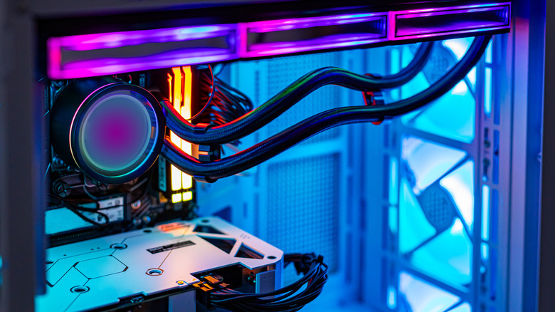 A close-up view of the interior of a high-end gaming PC showcasing the GPU, CPU cooler, and RGB fans.