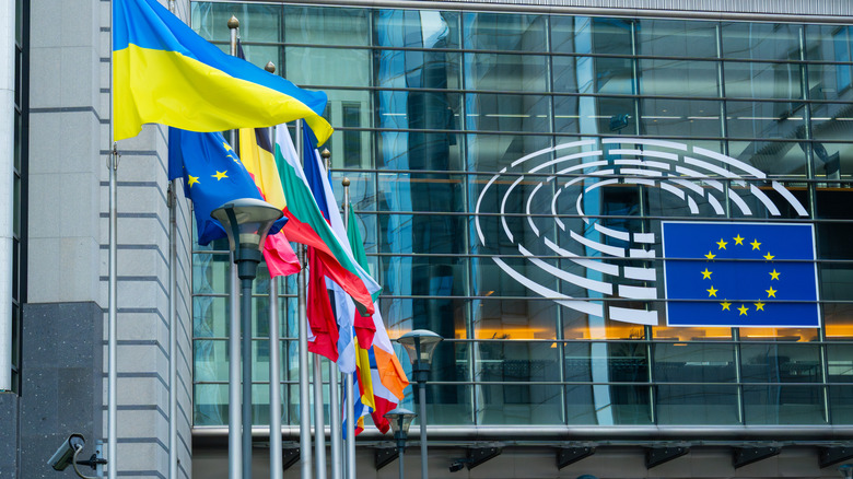 European Parliament Logo on Altiero Spinelli Building at Espace Leopold Complex and European Union Countries Flags in City of Brussels, Belgium