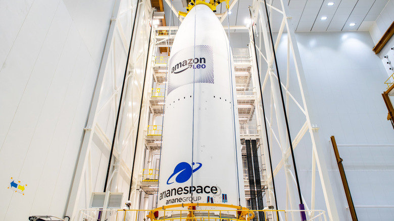 The Arianespace Ariane 6 rocket is showcased in a glowing white warehouse as it prepares for flight.