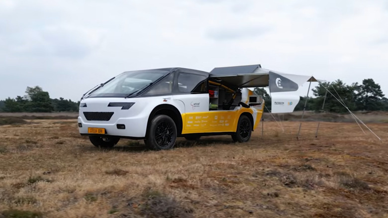 A side view of Solar Team Eindhoven's solar-powered ambulance with its wing-like arrays extended.