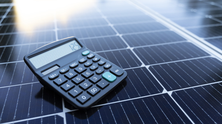 A calculator resting atop a solar panel