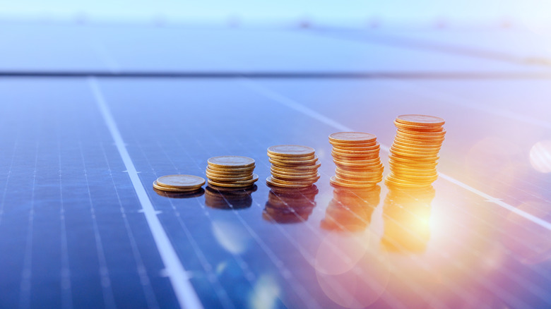 Piles of coins stacked on top of a solar panel