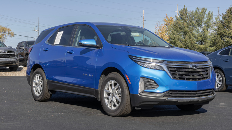 Blue Chevrolet Equinox parked in an outdoor dealership lot.
