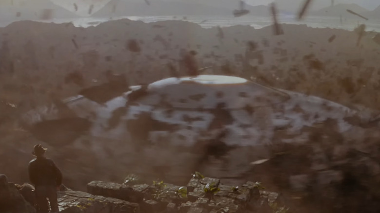 Indiana Jones watches a spaceship burst from the ground