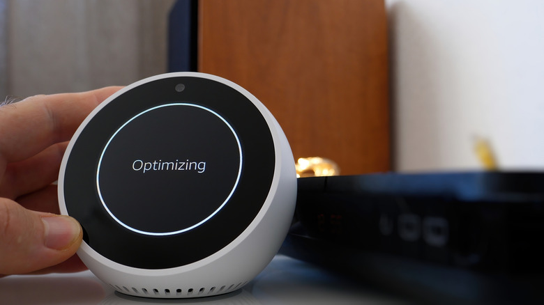 Amazon Echo Spot smart device with "optimizing" message on screen.