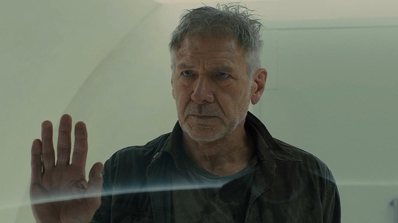 Deckard holding up his hand in Blade Runner 2049