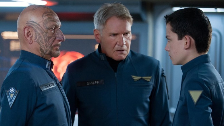 Ben Kingsley, Harrison Ford and Asa Butterfield in Ender's Game facing each other