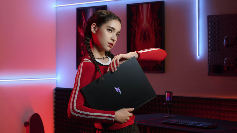 A woman holding the Acer Nitro gaming laptop.