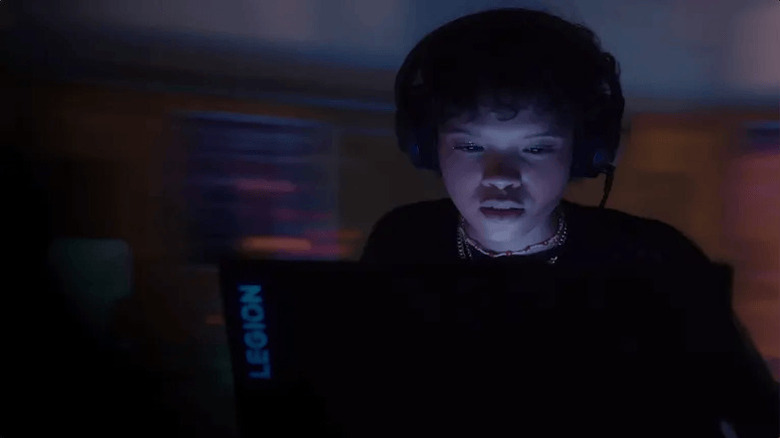 A person using Lenovo Legion in a dark room.