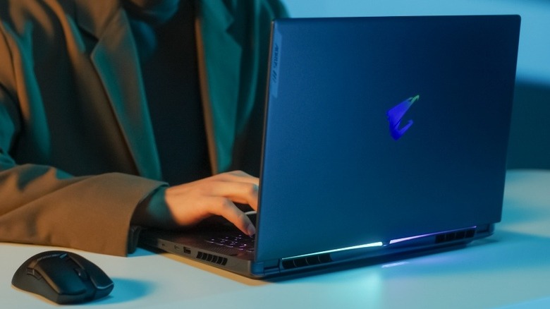 The back of Gigabyte Aorus laptop with the logo glowing from lighting.