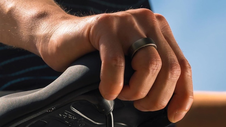 Amazfit Ring on someone's finger as they work on a bike