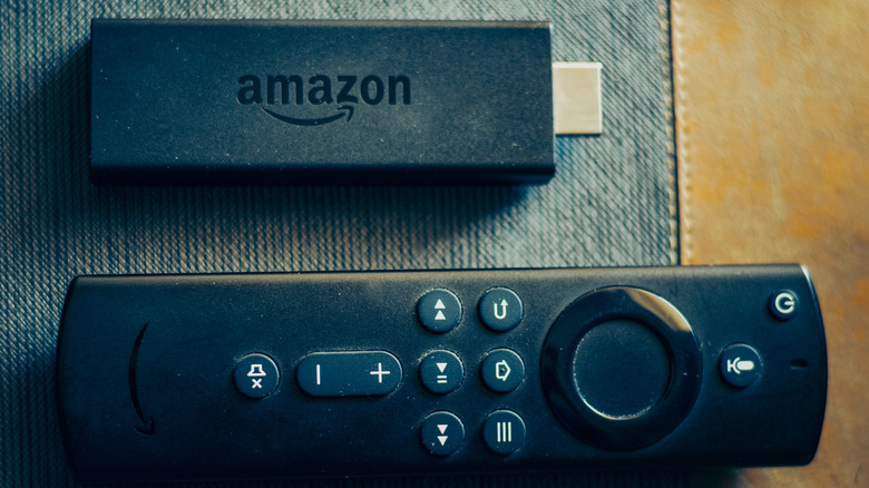Amazon Fire TV Stick lying next to the remote