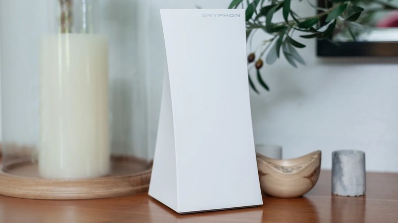 Gryphon Tower Wi-Fi Mesh unit on a table next to some candles