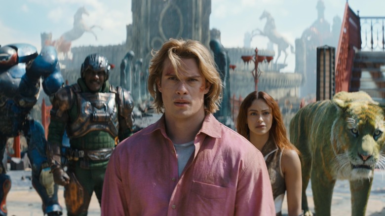 Roboto (Kristen Wiig), Man-At-Arms (Idris Elba), Adam (Nicholas Galitzine) and Teela (Camila Mendes) stood together in Masters of the Universe