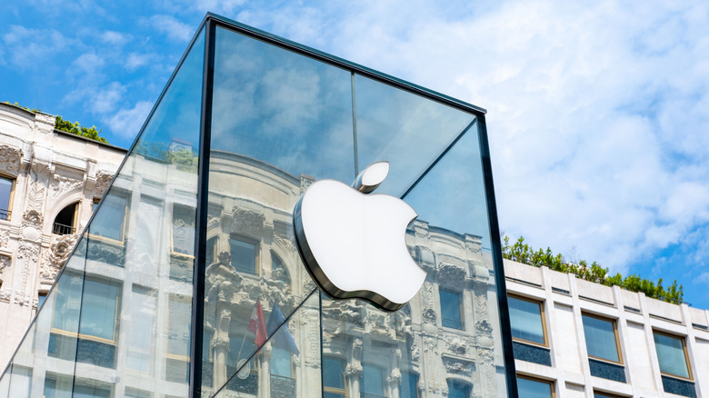 White Apple store logo on transparent glass storefront