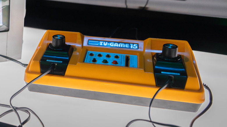 A yellow Color TV-Game on a white surface