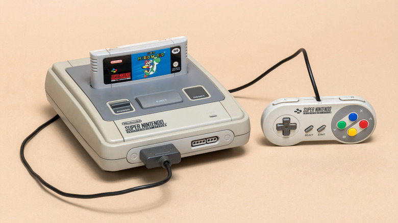 The Super Nintendo Entertainment System on a peach surface