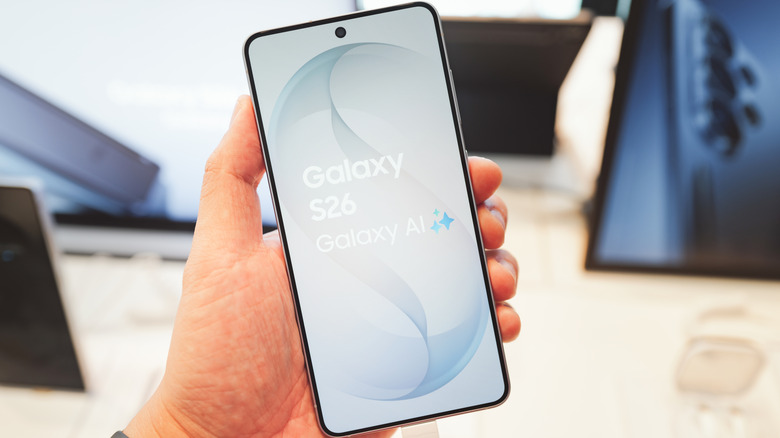person holding Samsung galaxy s26 smartphone showing name and Galaxy AI logo on display