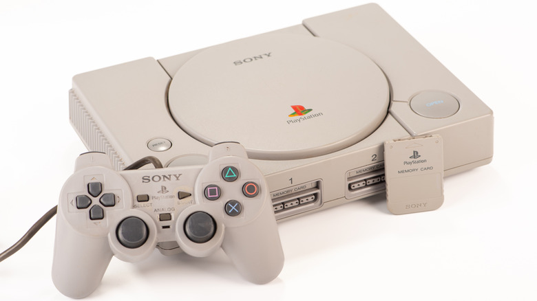 The first ever DualShock controller next to the original PlayStation