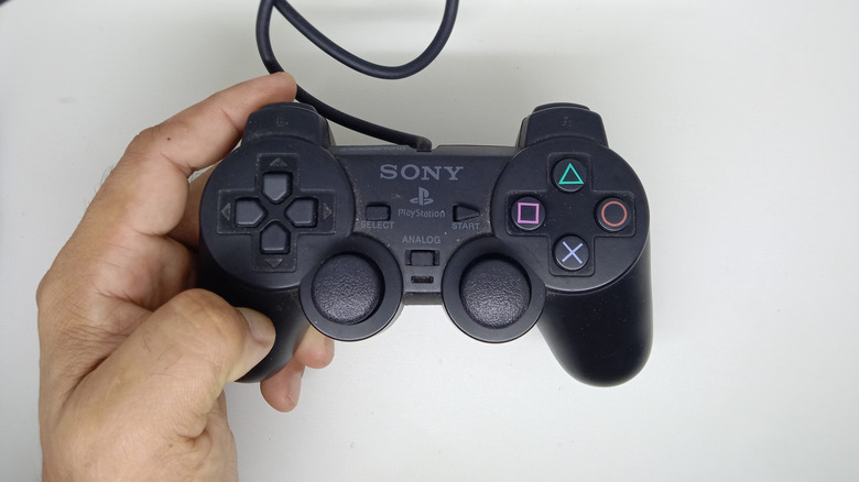 Holding the DualShock 2 controller