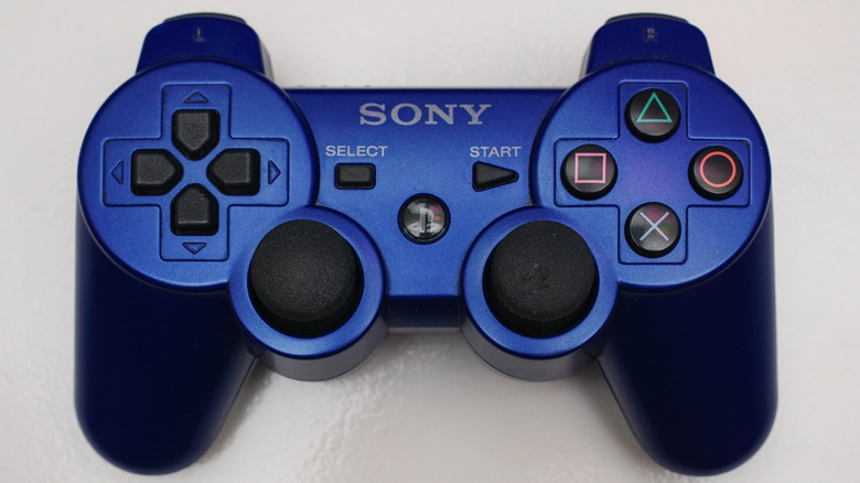 A blue DualShock 3 controller on a white surface