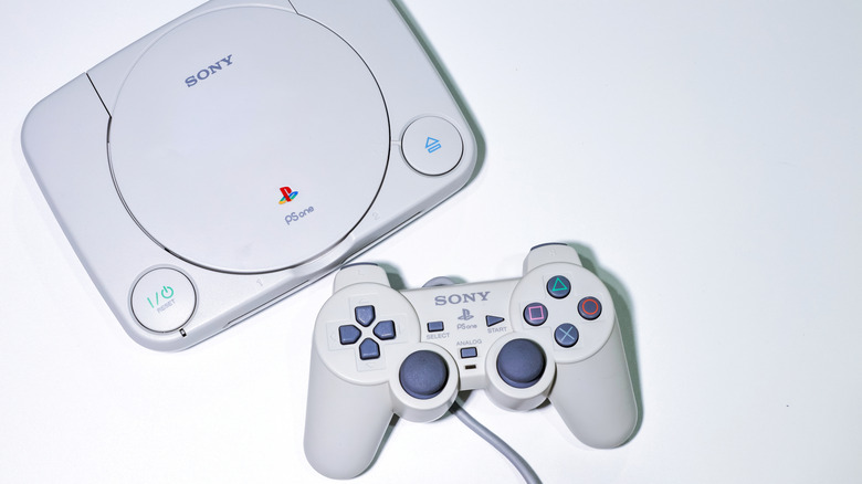 The updated PS One console with its special DualShock next to it