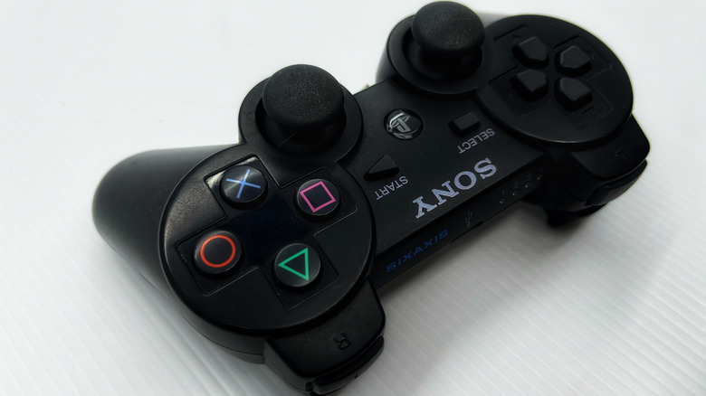 A black SIXAXIS Controller on a white surface