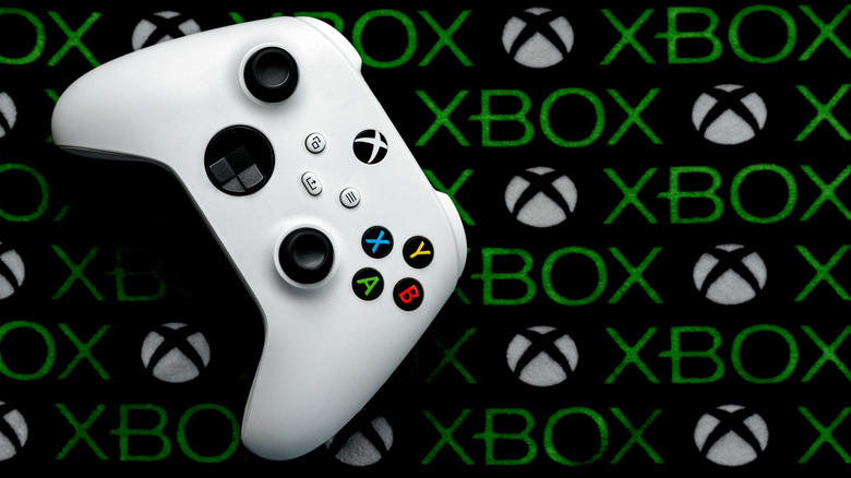 An Xbox gaming controller with the logo in the backdrop
