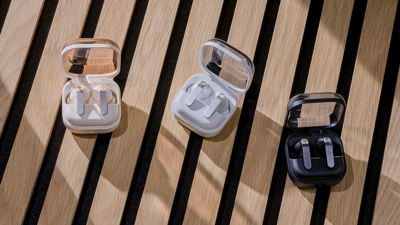 Samsung Galaxy Buds 4 Pro in three colors on a wooden bench